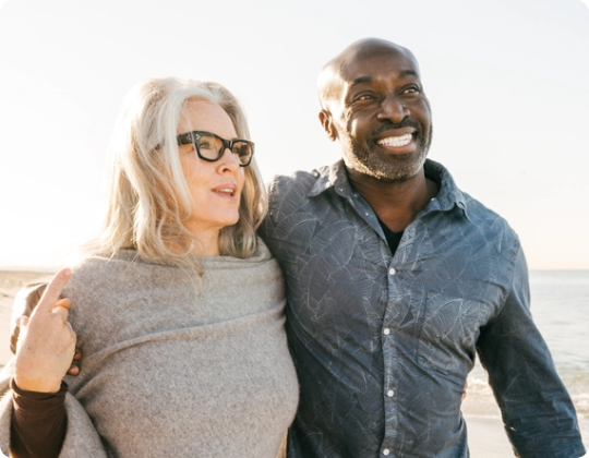 Interacial couple walking on the beach