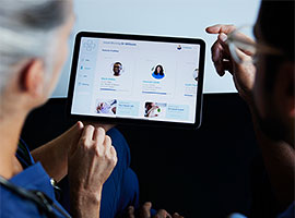 Doctors looking at a tablet