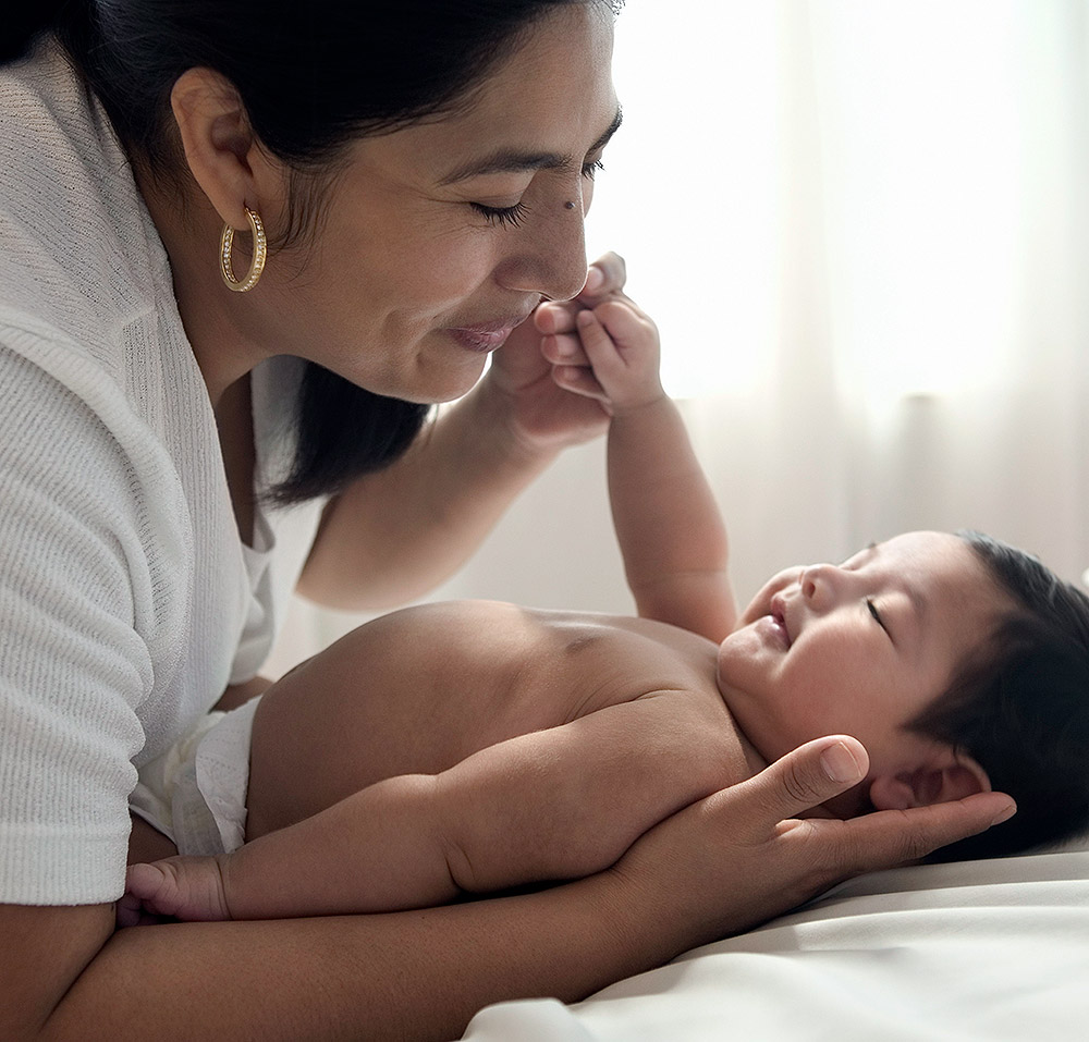 Photo of smiling mother with smiling baby